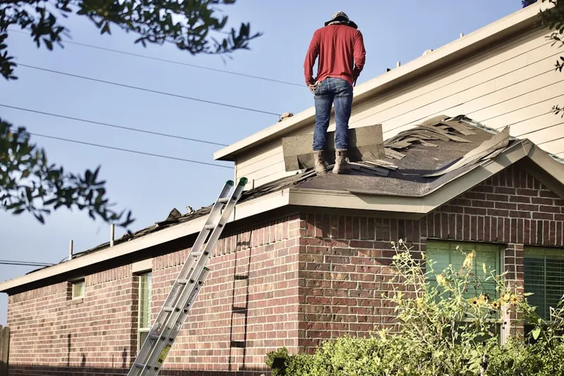 Professional roofer working on a residential roof in Penn Daw Village
